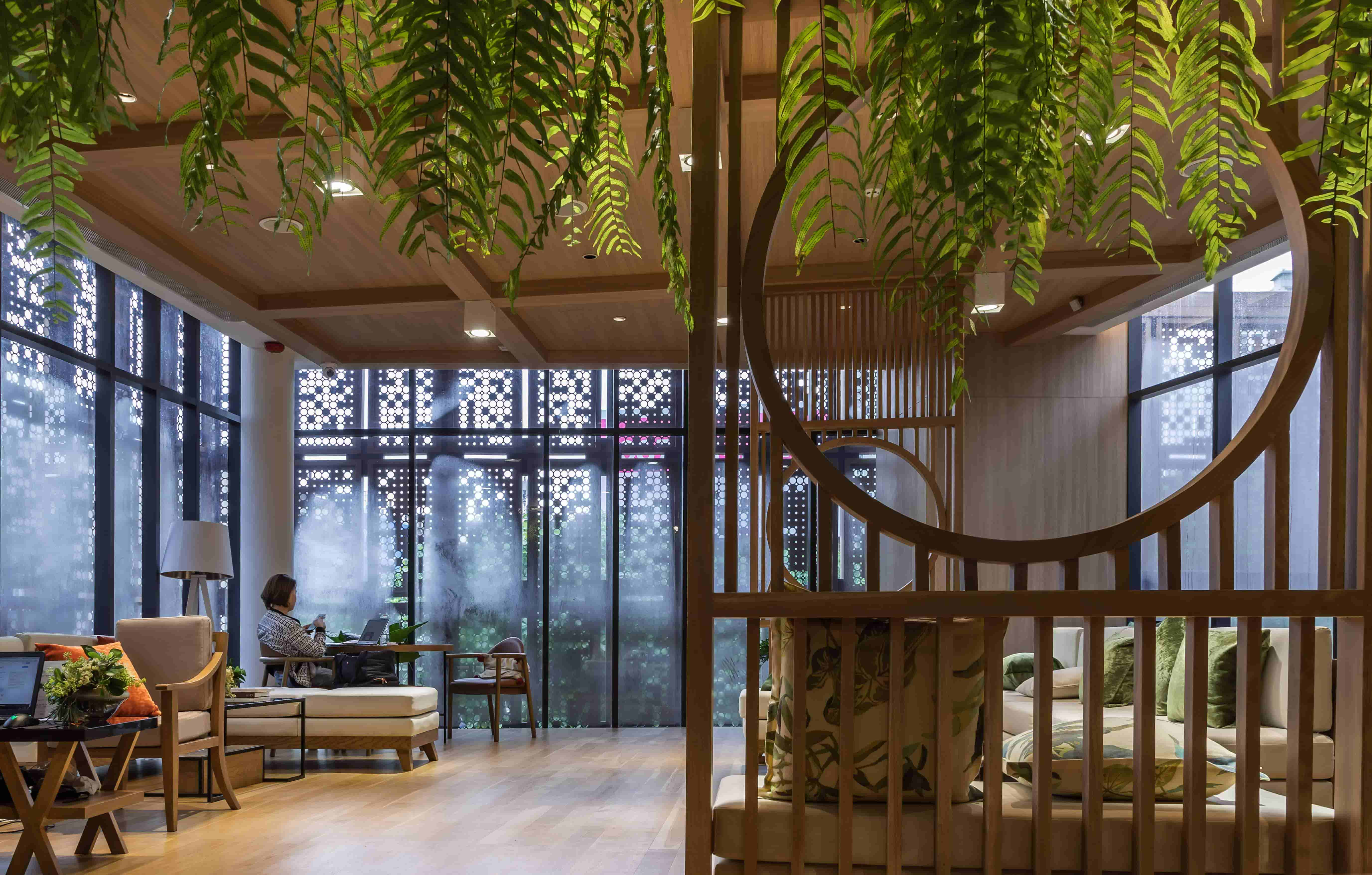 Modern biophilic interior design with curved staircase and natural elements